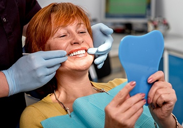 Woman smiling with dental implants in Garland