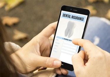Woman looking at dental insurance on her phone