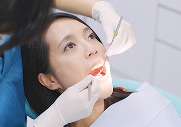 Woman receiving oral cancer screening