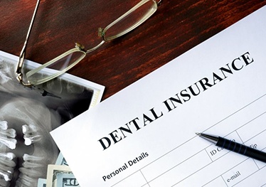 Form that says “dental insurance” on a desk