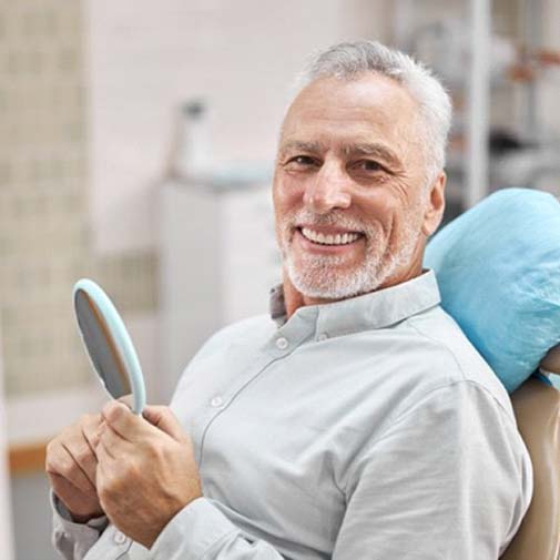 smiling man enjoying his new dental bridge in Garland, TX