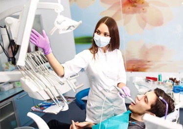 A dentist using an intraoral scanner on a patient.