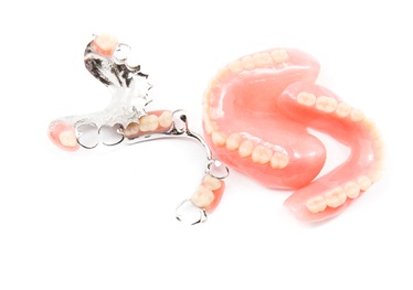 Closeup of full and partial dentures in Garland on white background