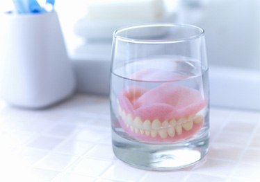 Dentures soaking in solution