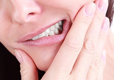 Closeup of patient holding jaw