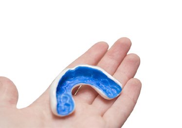 man holding mouthguard