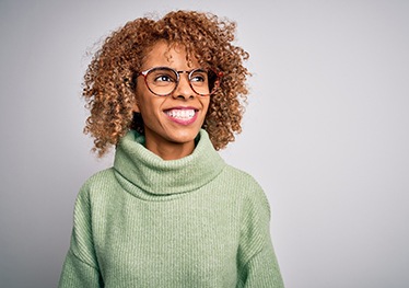 woman smiling about dental implant post-op instructions in Garland