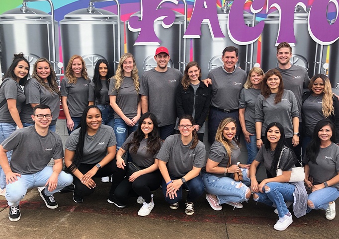 Garland dental team members at Dentistry by Brand in matching gray shirts