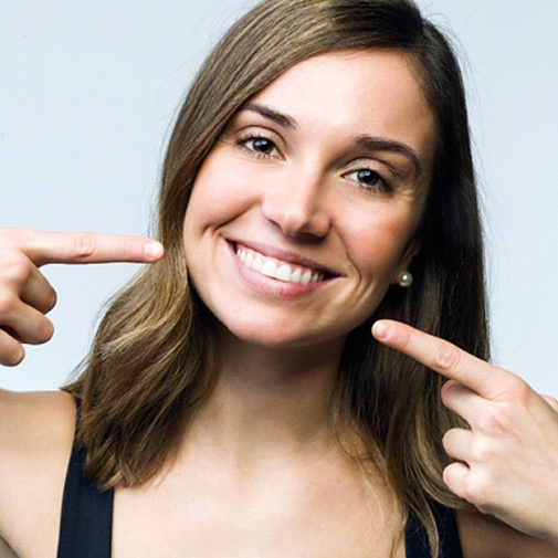 woman pointing to smile