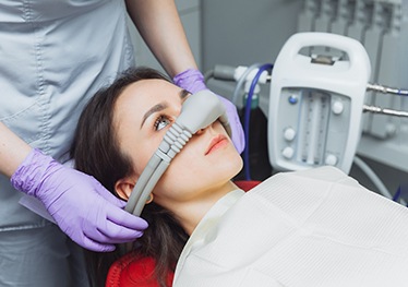 Woman with mask over nose for nitrous oxide sedation in Garland, TX