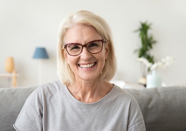 Older woman with glasses smiling