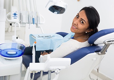 Happy dental patient looking over her shoulder