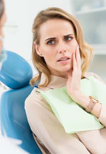 Woman talking to dentist about tooth pain in Murphy, TX