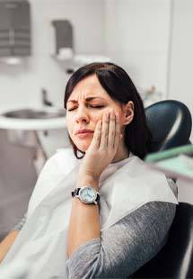 woman experiencing tooth pain