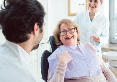 Dentist teaching patient about sleep apnea treatment in Garland