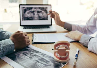 Dentist in Garland reviewing X-rays with patient