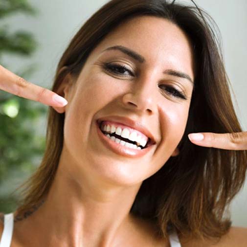 Woman smiling with porcelain veneers in Garland