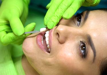 Woman having veneers in Garland placed by a dentist