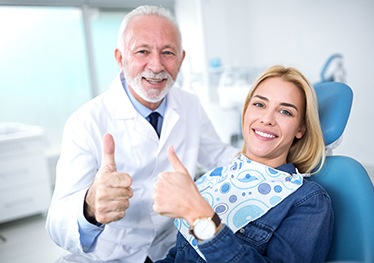 Cosmetic dentist in Garland and patient giving thumbs up sign