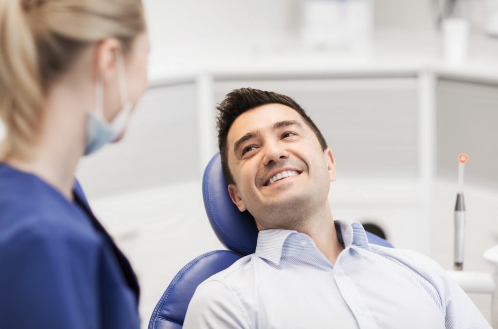 Patient and dentist smiling at each other