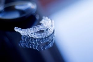 Set of clear aligners on a dark background